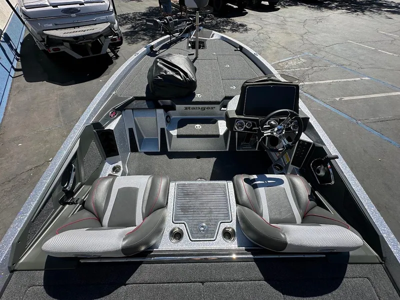 Slide: The Image of 2024 Ranger Z519 boat interior with dual seats and advanced dashboard controls. - 13