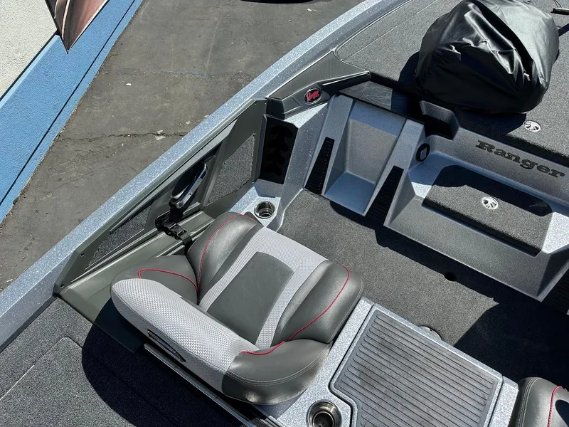 Slide: The Image of 2024 Ranger Z519 boat interior with gray seating and storage compartments. - 14