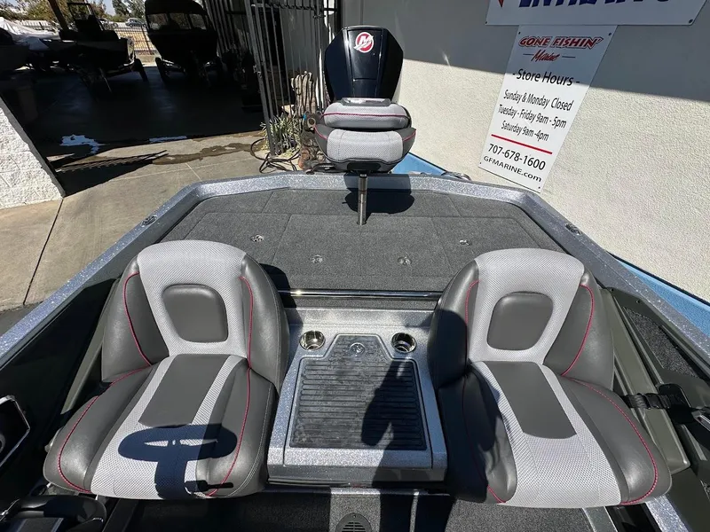 Slide: The Image of 2024 Ranger Z519 boat interior with two gray seats and a central console. - 16