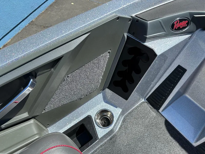 Slide: The Image of 2024 Ranger Z519 boat interior with storage compartments and cup holder. - 17