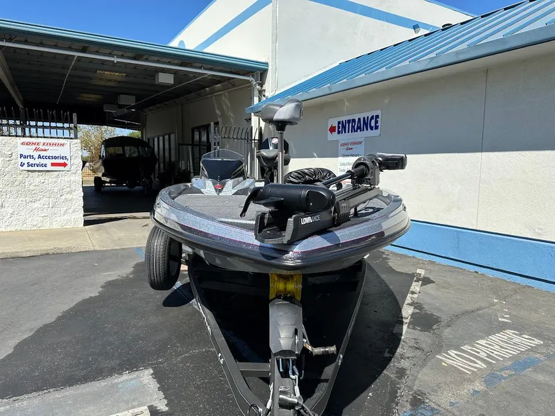 Slide: The Image of 2024 Ranger Z519 boat parked outside service entrance. - 2