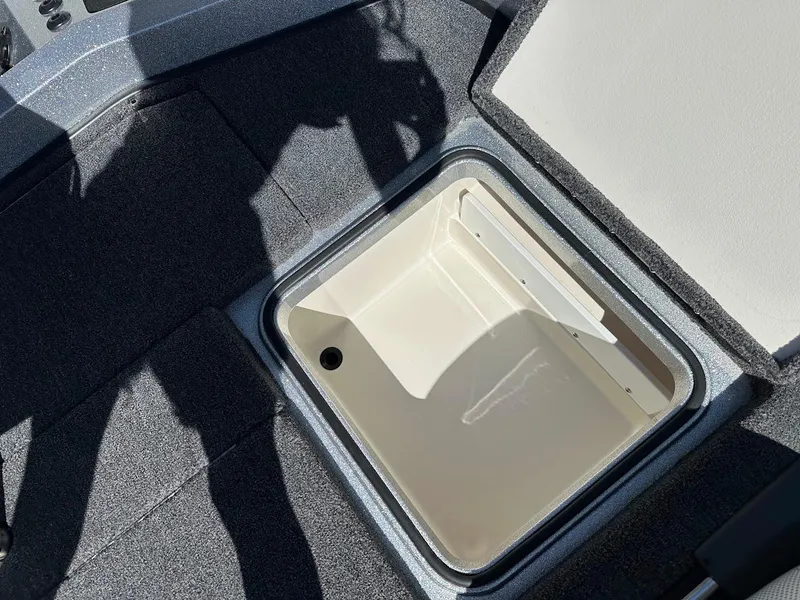 Slide: The Image of 2024 Ranger Z519 boat storage compartment with open lid, showing interior details. - 31