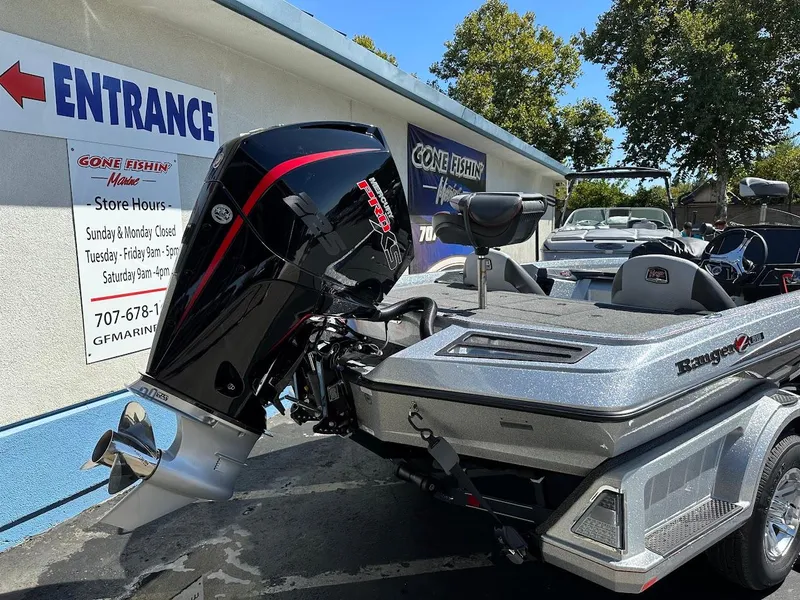Slide: The Image of 2024 Ranger Z519 boat with powerful outboard motor, parked near a store entrance. - 8
