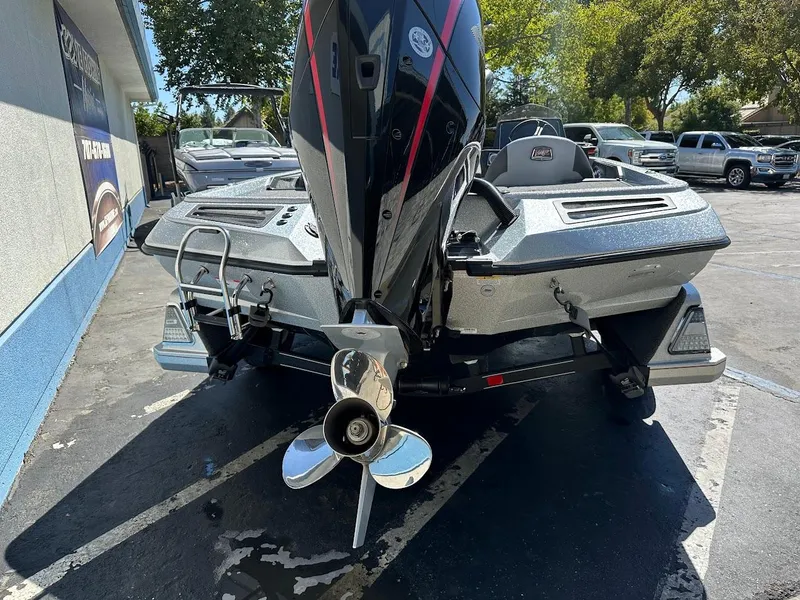 Slide: The Image of 2024 Ranger Z519 boat with powerful outboard motor, parked outdoors. - 9