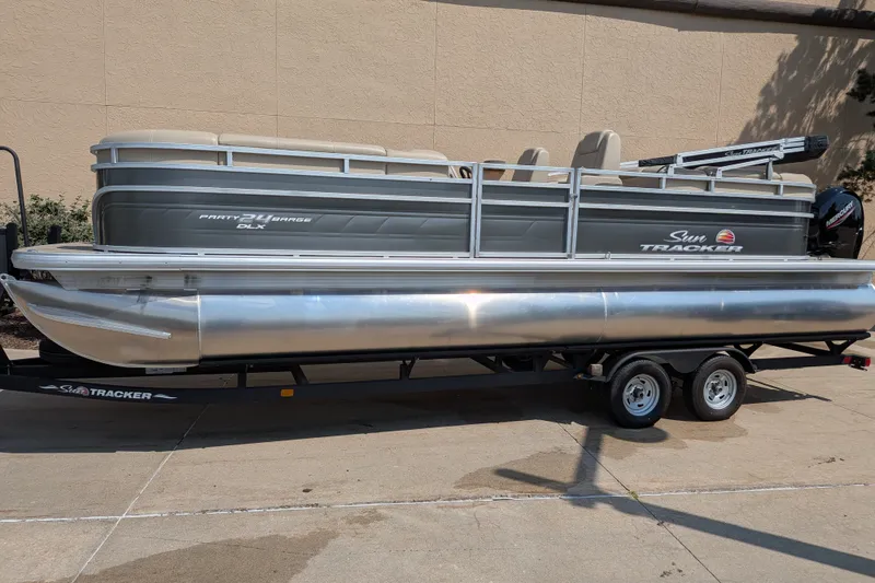 The Image of 2024 Sun Tracker Party Barge 24 DLX pontoon boat on trailer, side view. - 0