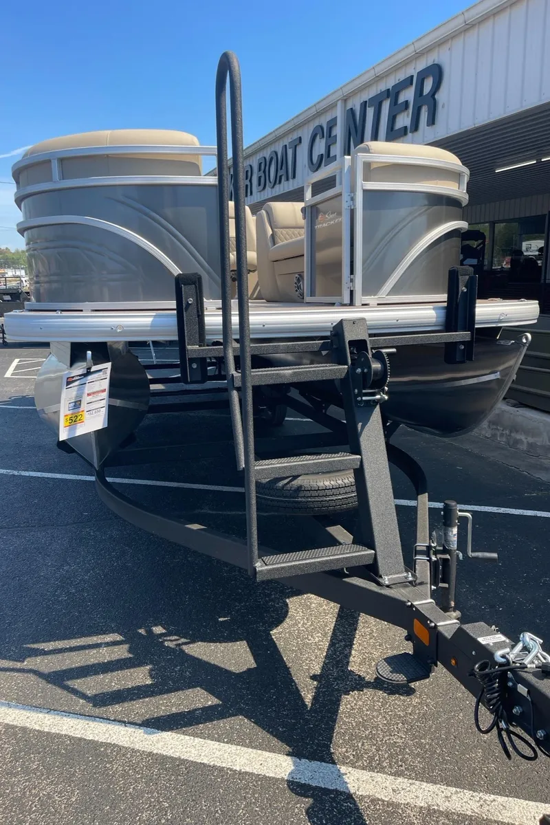 Slide: The Image of 2024 Sun Tracker Party Barge 24 DLX pontoon boat on trailer at dealership. - 21