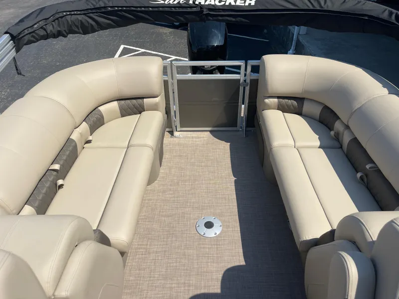 Slide: The Image of 2024 Sun Tracker Party Barge 24 DLX interior with beige seating and spacious layout. - 8
