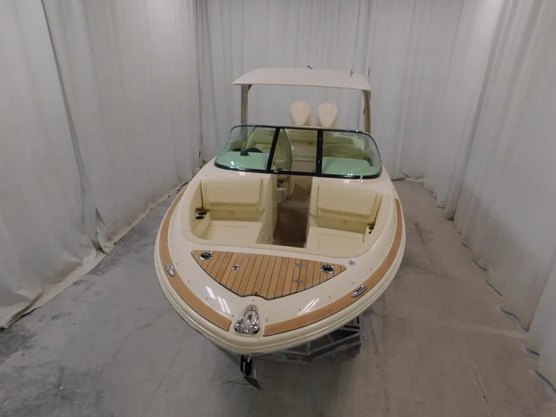 Slide: The Image of 2024 Chris-Craft Calypso 28 boat in showroom. - 2