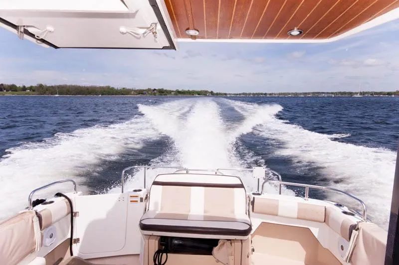 Slide: The Image of 2016 Cutwater 30 Sedan cruising on open water, view from the stern. - 10