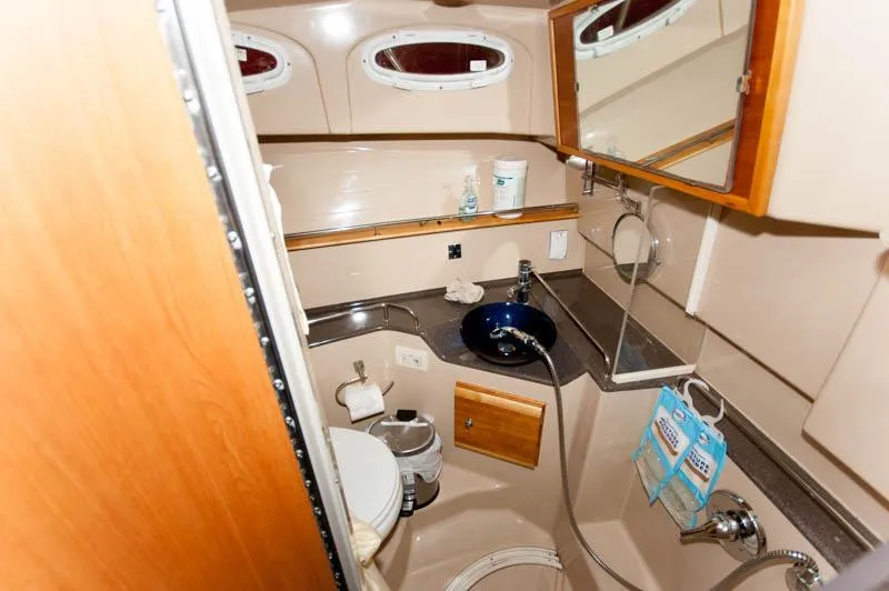 Slide: The Image of 2016 Cutwater 30 Sedan boat bathroom with sink, toilet, and mirror. - 18