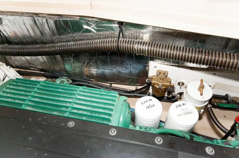 Slide: The Image of Engine compartment of a 2016 Cutwater 30 Sedan boat with visible filters and wiring. - 24