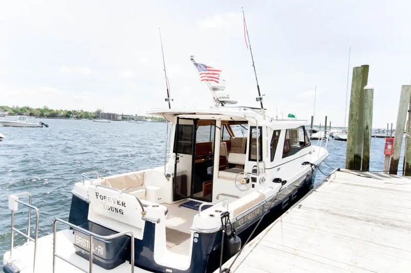 Slide: The Image of 2016 Cutwater 30 Sedan boat docked at a marina. - 3