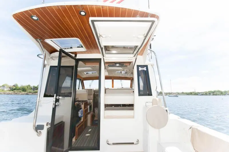 Slide: The Image of 2016 Cutwater 30 Sedan boat interior with open doors and windows. - 4