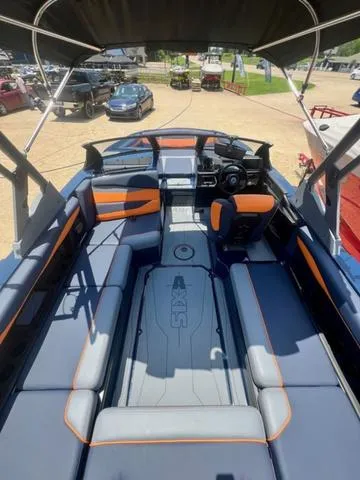 Slide: The Image of 2024 Axis Wake Research A225 boat interior with modern seating and dashboard. - 11