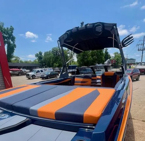 Slide: The Image of 2024 Axis Wake Research A225 boat with orange and gray seating. - 3