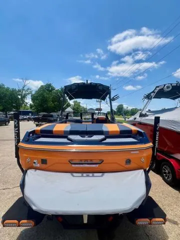 Slide: The Image of 2024 Axis Wake Research A225 boat, rear view, in a parking lot. - 4