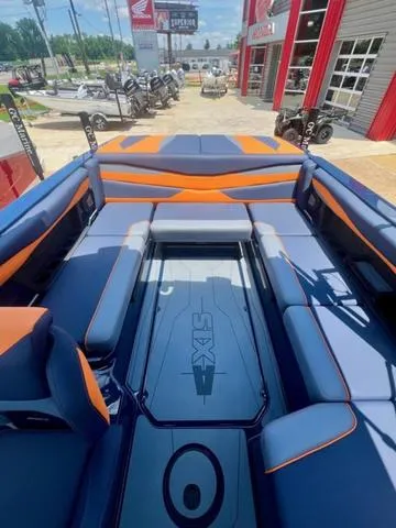 Slide: The Image of 2024 Axis Wake Research A225 boat interior with blue and orange seating. - 6