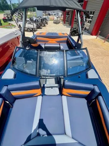 Slide: The Image of 2024 Axis Wake Research A225 boat with blue and orange interior. - 9