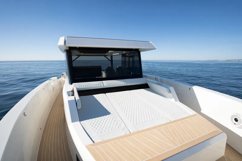 Slide: The Image of 2024 De Antonio Yachts D50 Coupé on calm sea, showcasing sleek design and luxury features. - 12