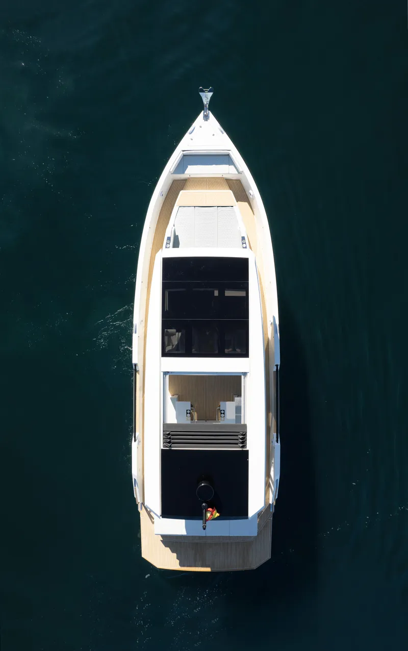 Slide: The Image of 2024 De Antonio Yachts D50 Coupé, aerial view, sleek design on calm water. - 19