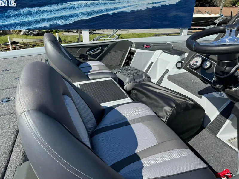 Slide: The Image of 2024 Ranger 518 Cup boat interior with gray seating and modern dashboard. - 4