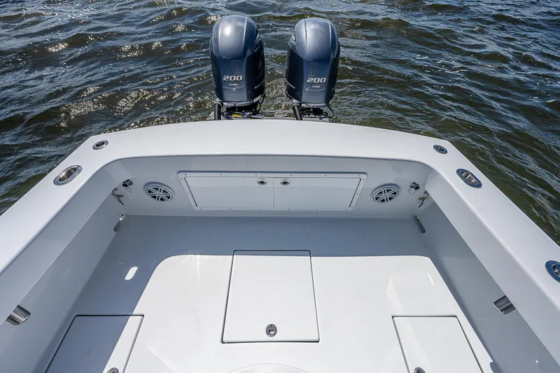 Slide: The Image of 1969 Bertram 25 Moppie boat with twin outboard engines on water. - 11