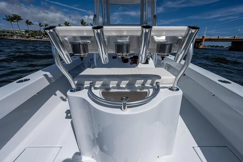 Slide: The Image of 1969 Bertram 25 Moppie boat interior with rod holders and clean white deck. - 14
