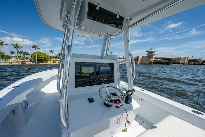 Slide: The Image of 1969 Bertram 25 Moppie boat cockpit with modern navigation equipment on a sunny day. - 19