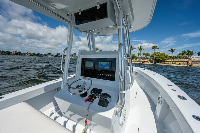 Slide: The Image of 1969 Bertram 25 Moppie boat console with steering wheel and navigation screens. - 20