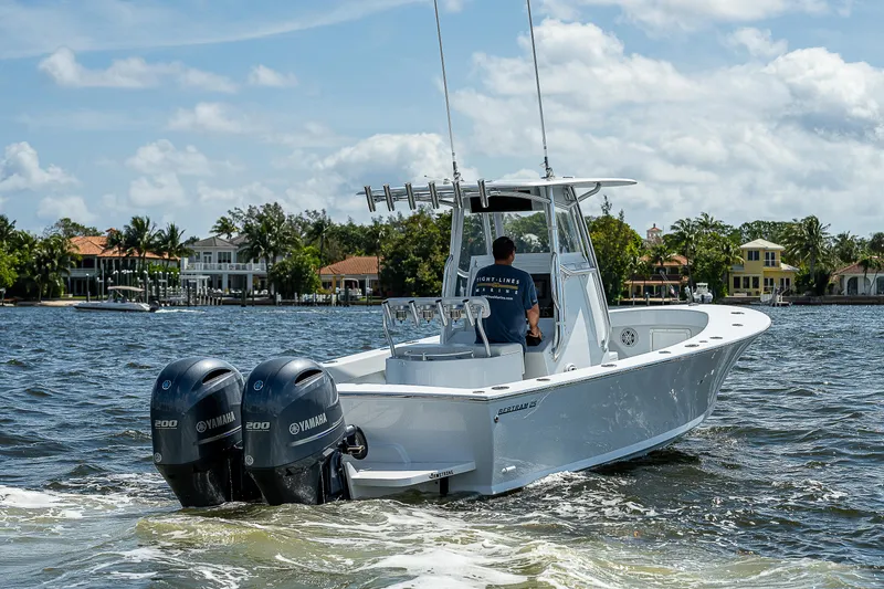 Slide: The Image of 1969 Bertram 25 Moppie boat cruising on a sunny day with twin Yamaha outboard engines. - 26