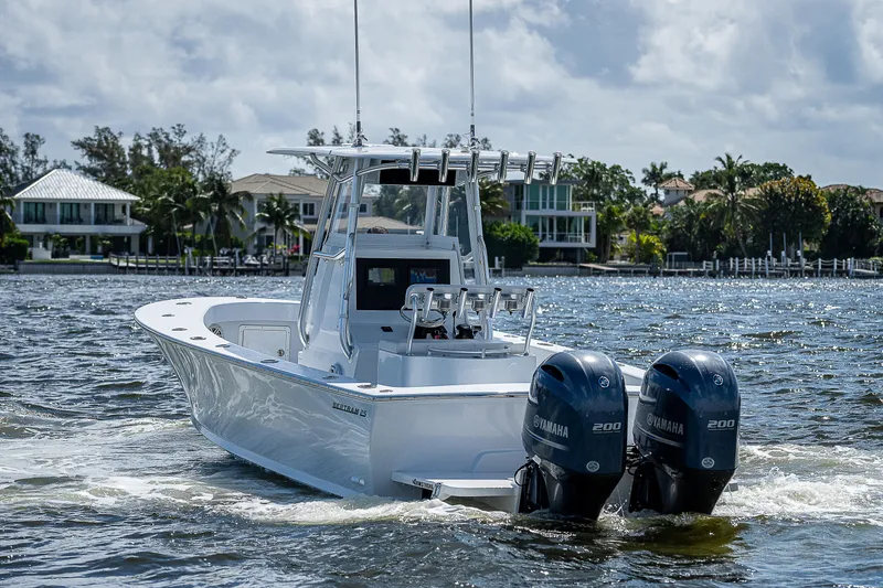 Slide: The Image of 1969 Bertram 25 Moppie boat with twin Yamaha 200 engines on the water. - 35