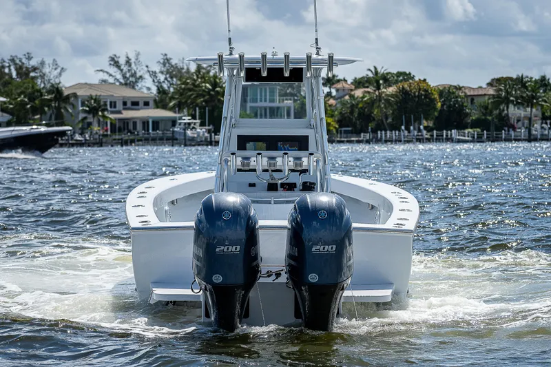 Slide: The Image of 1969 Bertram 25 Moppie boat with twin engines cruising on water. - 36