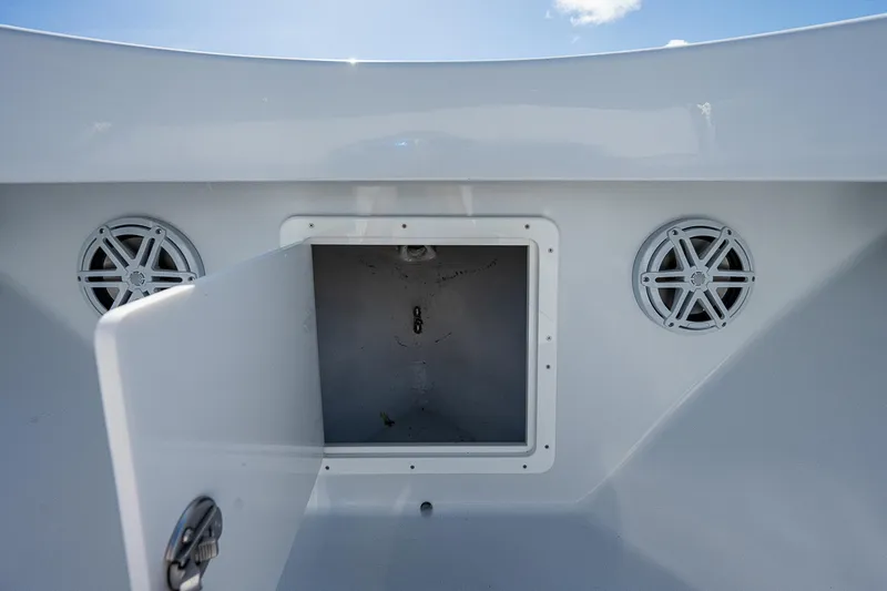 Slide: The Image of Open storage compartment on a 1969 Bertram 25 Moppie boat with speakers. - 4