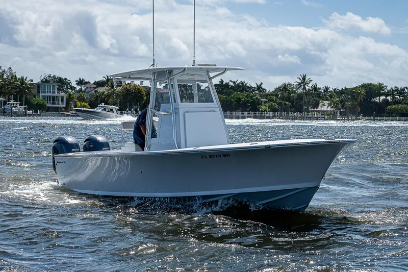 Slide: The Image of 1969 Bertram 25 Moppie boat cruising on water with scenic background. - 40