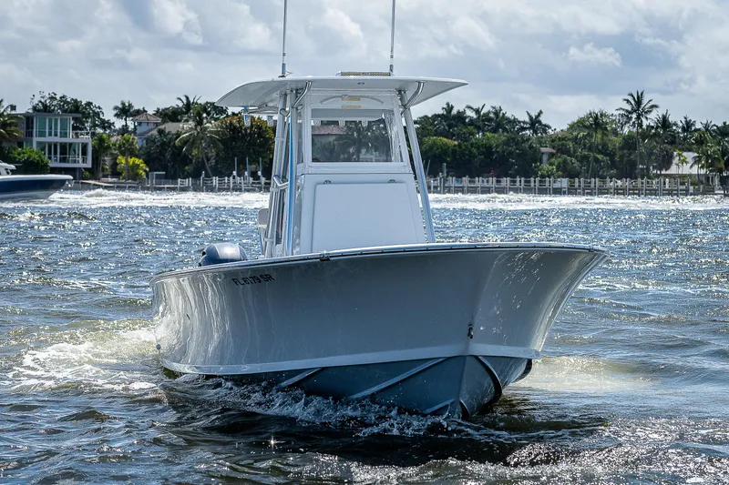 Slide: The Image of 1969 Bertram 25 Moppie boat cruising on water, front view. - 41
