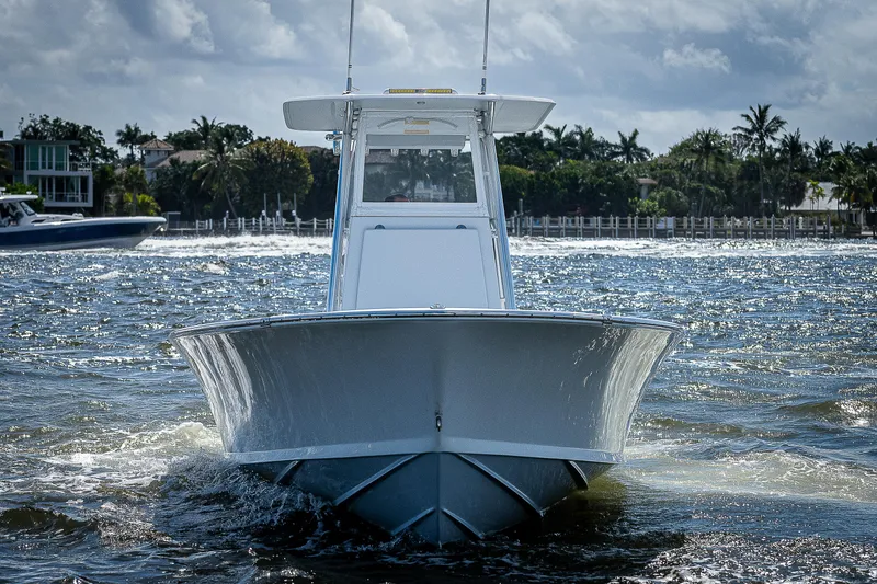 Slide: The Image of 1969 Bertram 25 Moppie boat cruising on water, front view. - 42