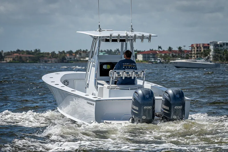 Slide: The Image of 1969 Bertram 25 Moppie boat cruising on water with twin Yamaha engines. - 45