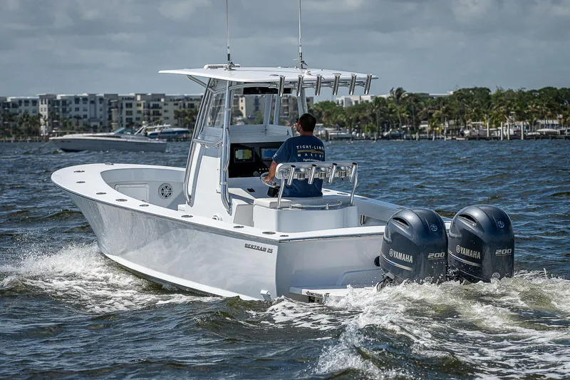 Slide: The Image of 1969 Bertram 25 Moppie boat cruising on water with twin Yamaha engines. - 46