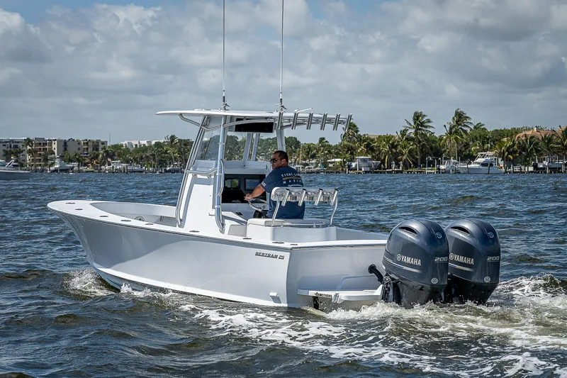 Slide: The Image of 1969 Bertram 25 Moppie boat cruising on water with twin Yamaha outboard engines. - 47
