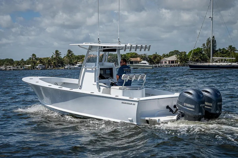 Slide: The Image of 1969 Bertram 25 Moppie boat cruising on water with twin Yamaha engines. - 48