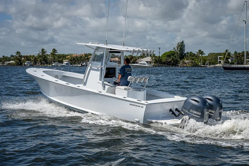 Slide: The Image of 1969 Bertram 25 Moppie boat cruising on water with twin Yamaha engines. - 49