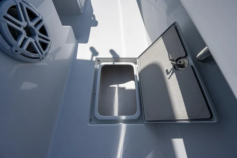 Slide: The Image of 1969 Bertram 25 Moppie boat deck with open storage compartment and speaker. - 8