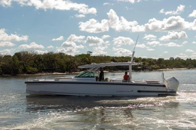 Slide: The Image of 2024 Axopar 37 Sun Top boat cruising on a sunny day. - 11
