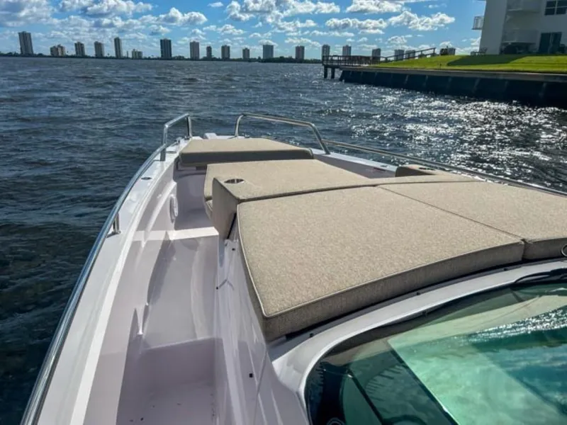Slide: The Image of 2024 Axopar 37 Sun Top boat with sunbathing area on a sunny day. - 14