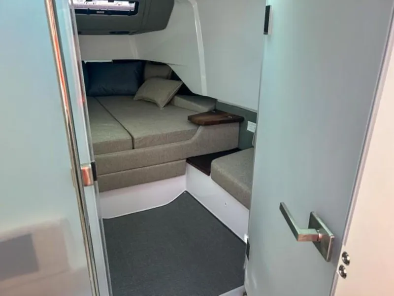 Slide: The Image of 2024 Axopar 37 Sun Top cabin interior with cozy bed and modern design. - 18