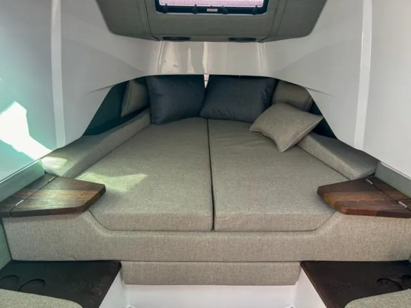 Slide: The Image of 2024 Axopar 37 Sun Top cabin interior with cozy bed and cushions. - 19