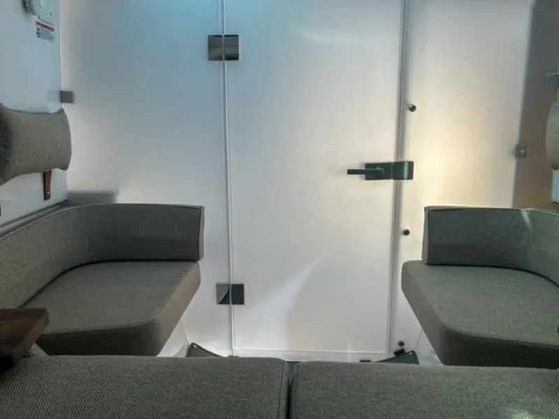 Slide: The Image of Interior seating of 2024 Axopar 37 Sun Top boat, featuring modern gray upholstery. - 20