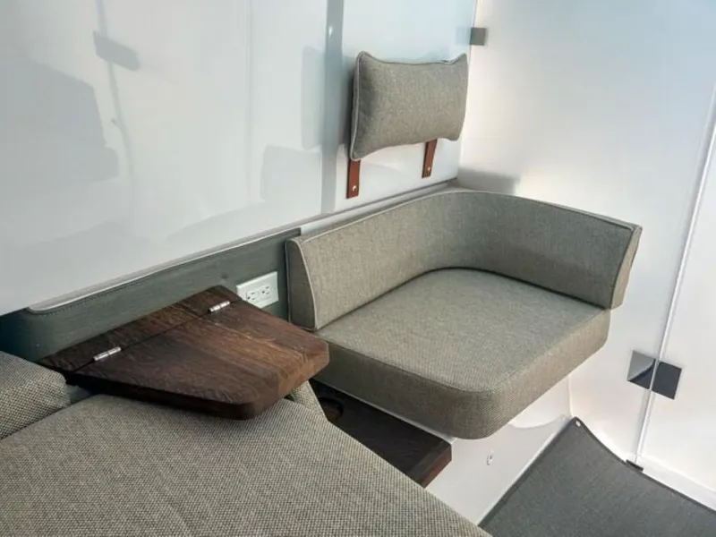 Slide: The Image of Interior seating of 2024 Axopar 37 Sun Top with modern design and wooden accents. - 21