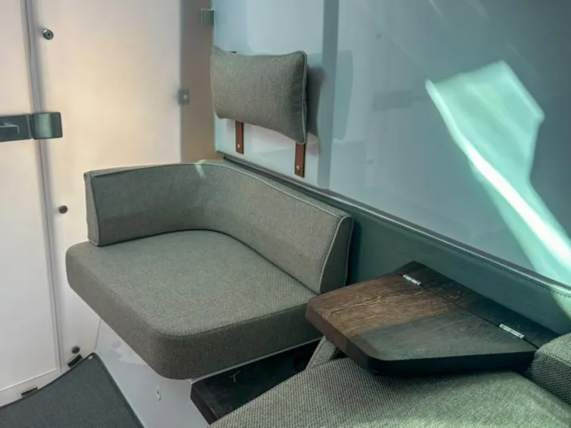 Slide: The Image of 2024 Axopar 37 Sun Top interior seating with modern design and comfortable cushions. - 22