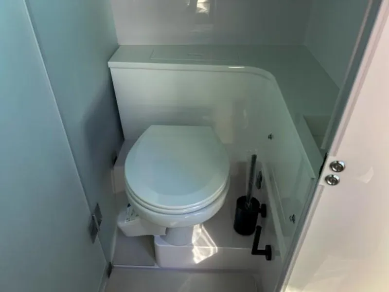 Slide: The Image of 2024 Axopar 37 Sun Top boat bathroom interior with modern toilet design. - 23